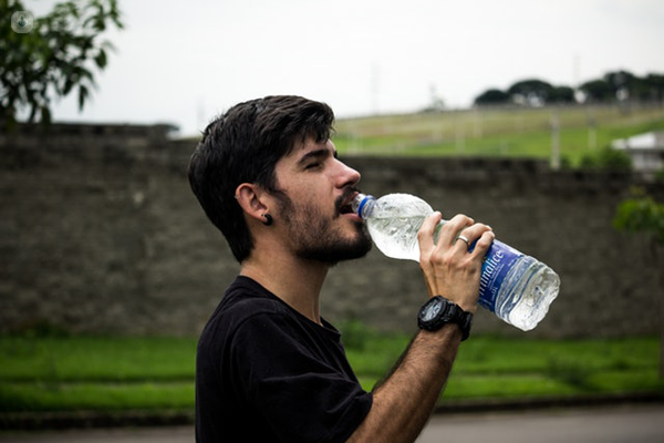 ragazzo che beve acqua da una bottiglia